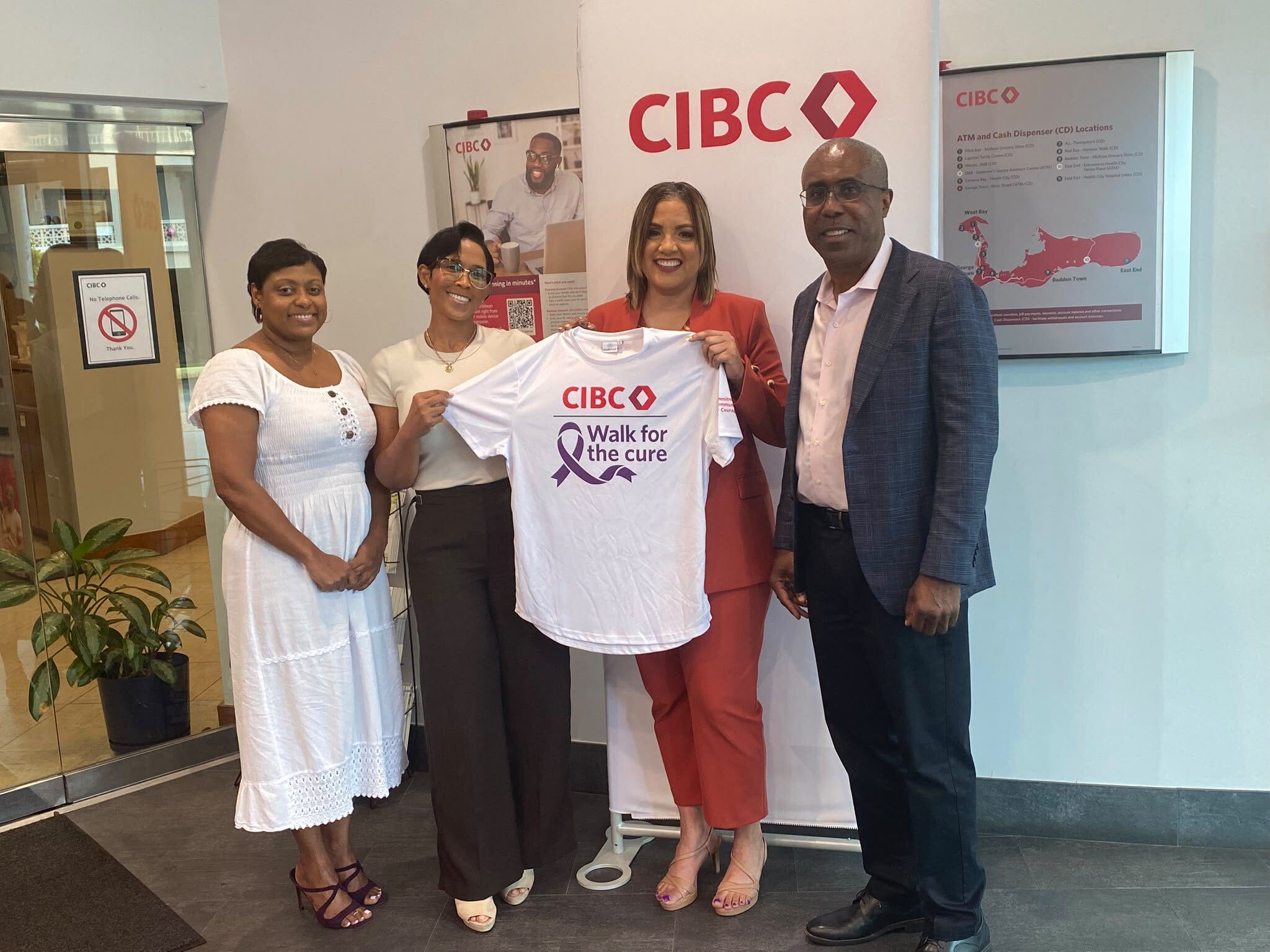 Four people at CIBC holding an event T-shirt to mark the Foundation’s Diamond Sponsorship.